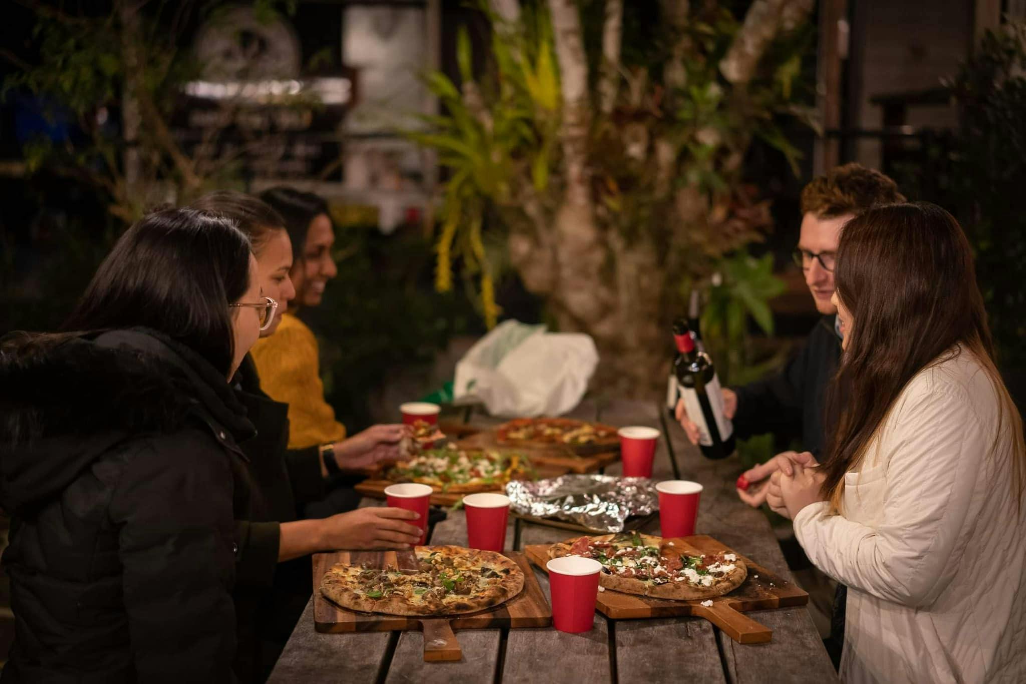Friends enjoying pizza night in Clunes