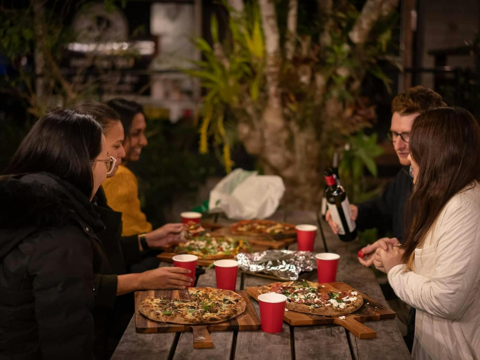 Friends enjoying pizza night in Clunes