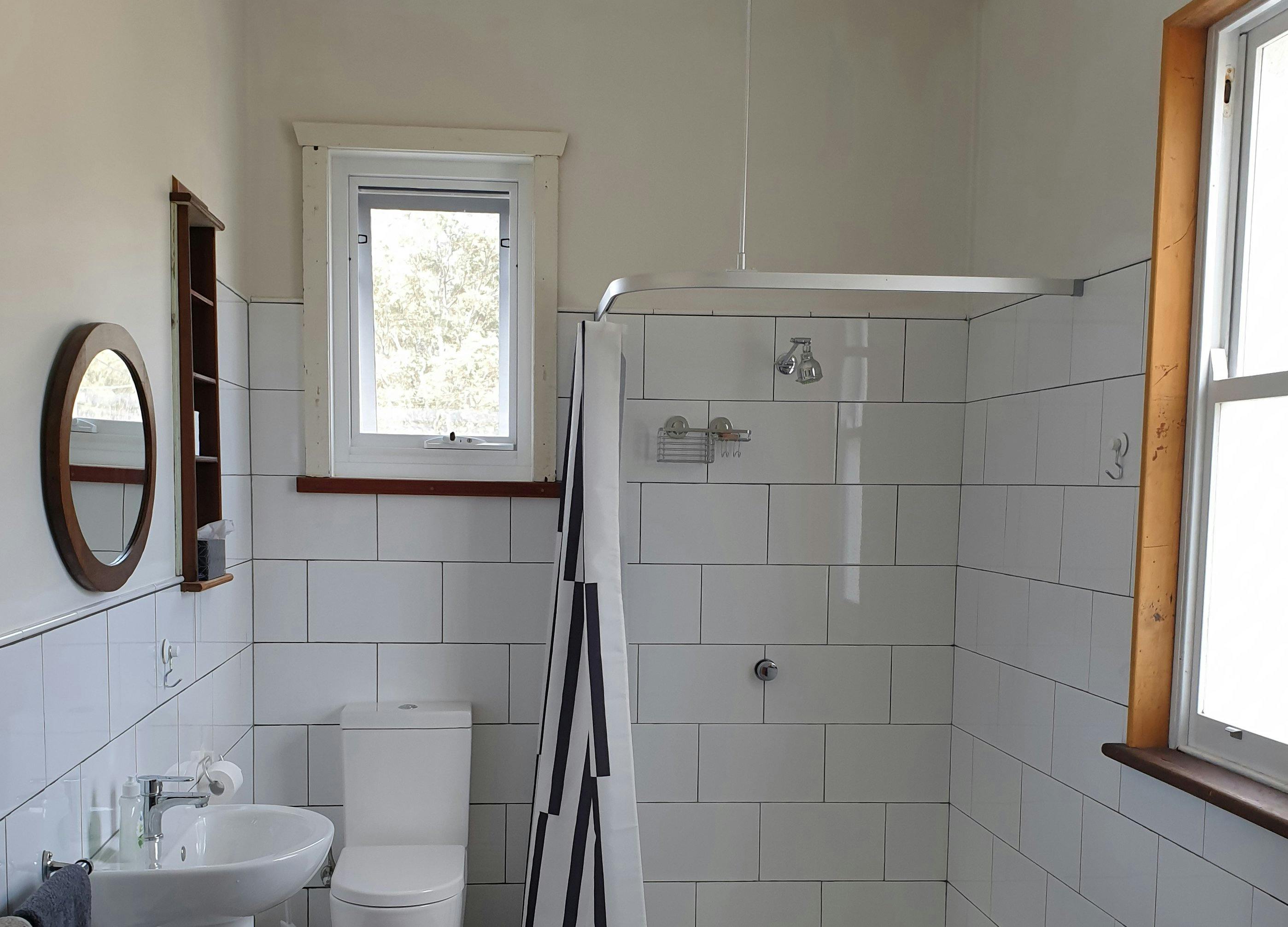White-tiled bathroom with shower