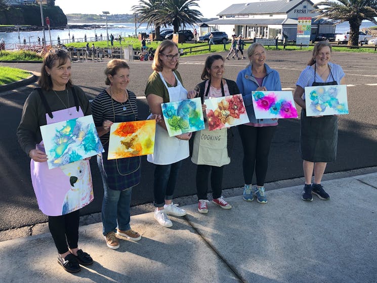 Kiama Art Workshops students holding their work at our Alcohol Inks workshop