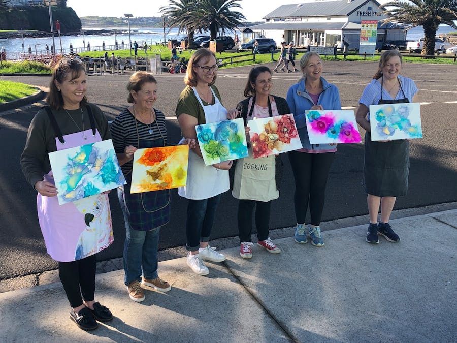 Kiama Art Workshops students holding their work at our Alcohol Inks workshop