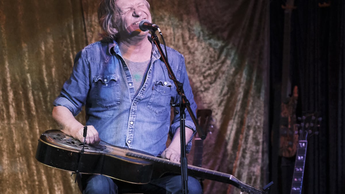 Charlie Owen, playing slide guitar