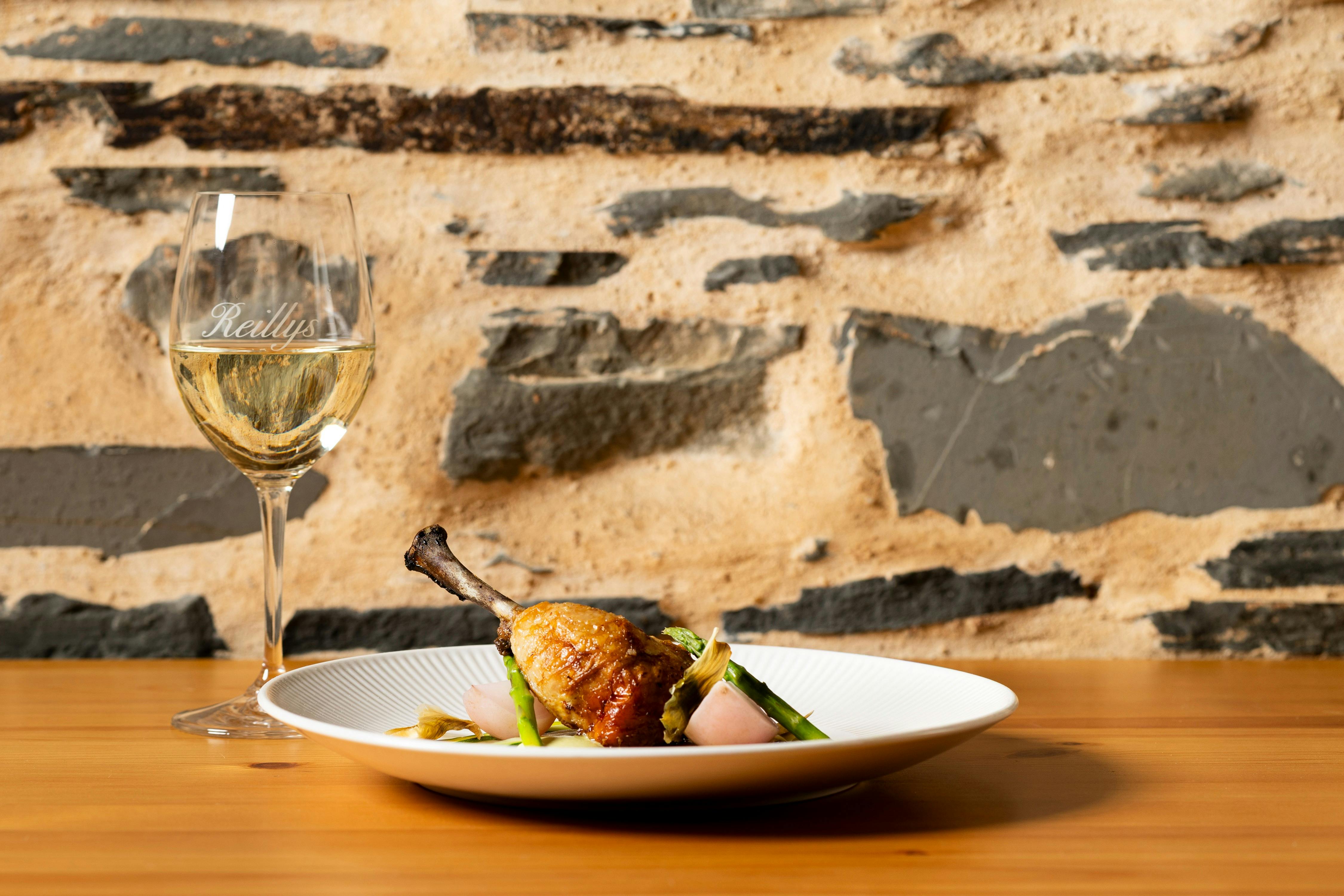 Stuffed chicken leg with glass of white wine