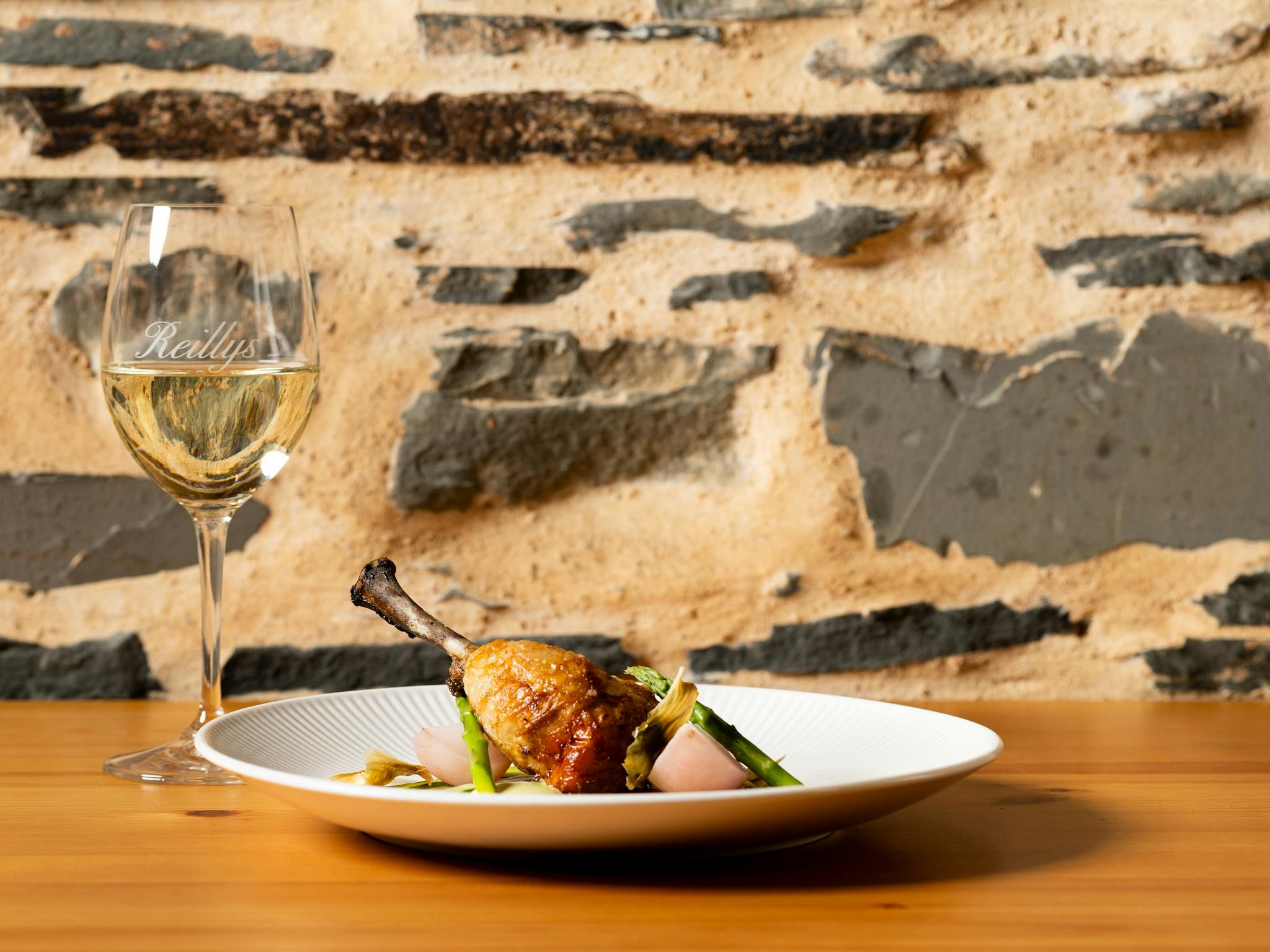 Stuffed chicken leg with glass of white wine