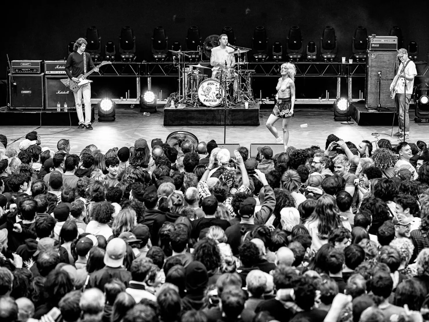 Black and white live shot of Amyl and the Sniffers on stage