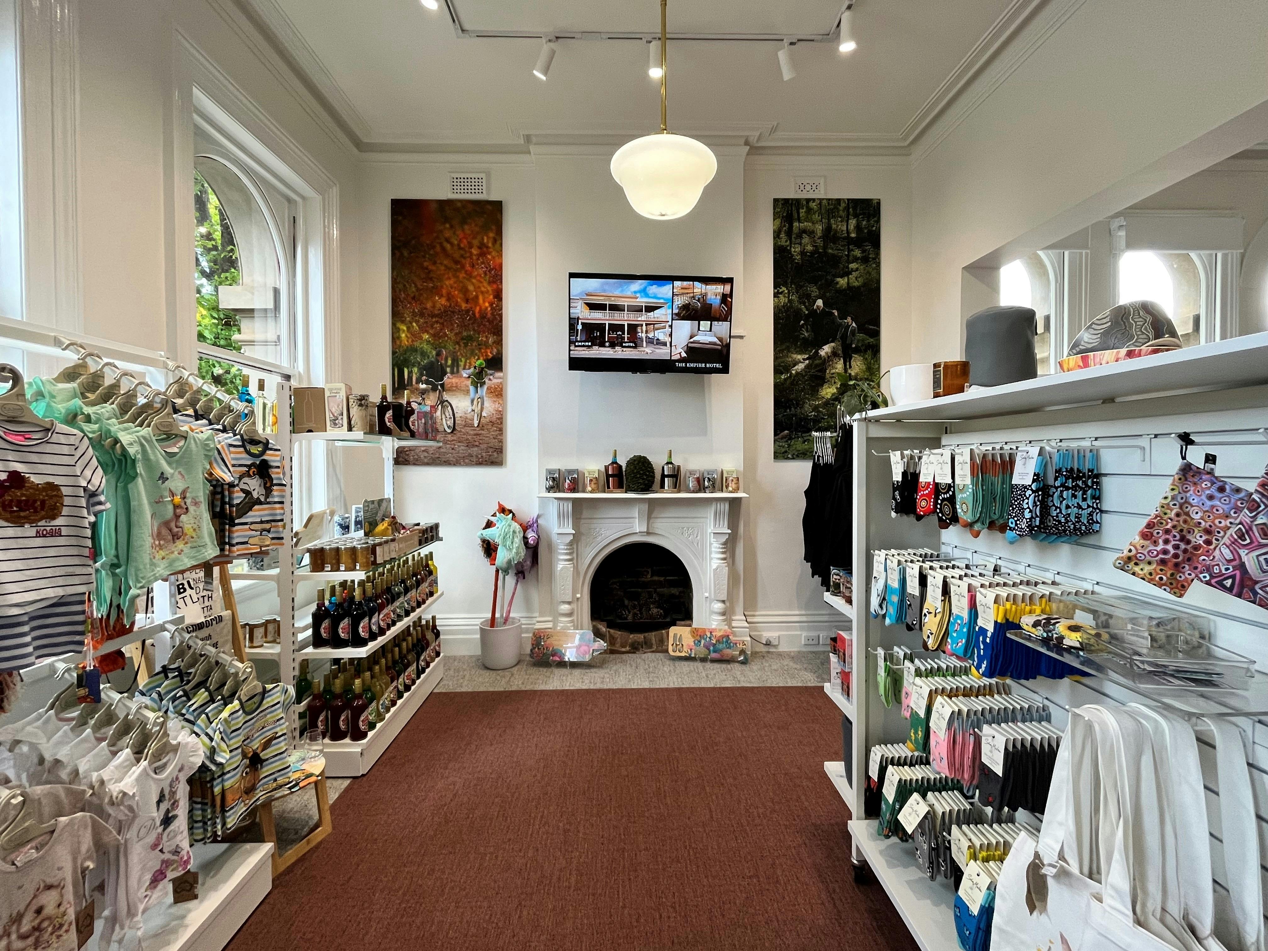 Inside the Centre, high ceilings, bright white walls and grey and maroon carpet. Fireplace on wall.