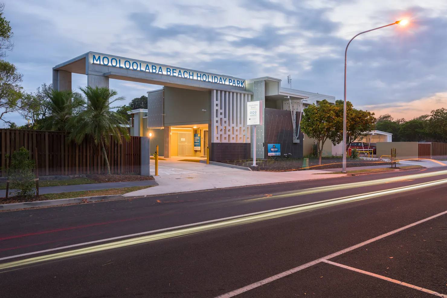 Shot of Mooloolaba Beach Holiday Park entrance at dusk with lights on