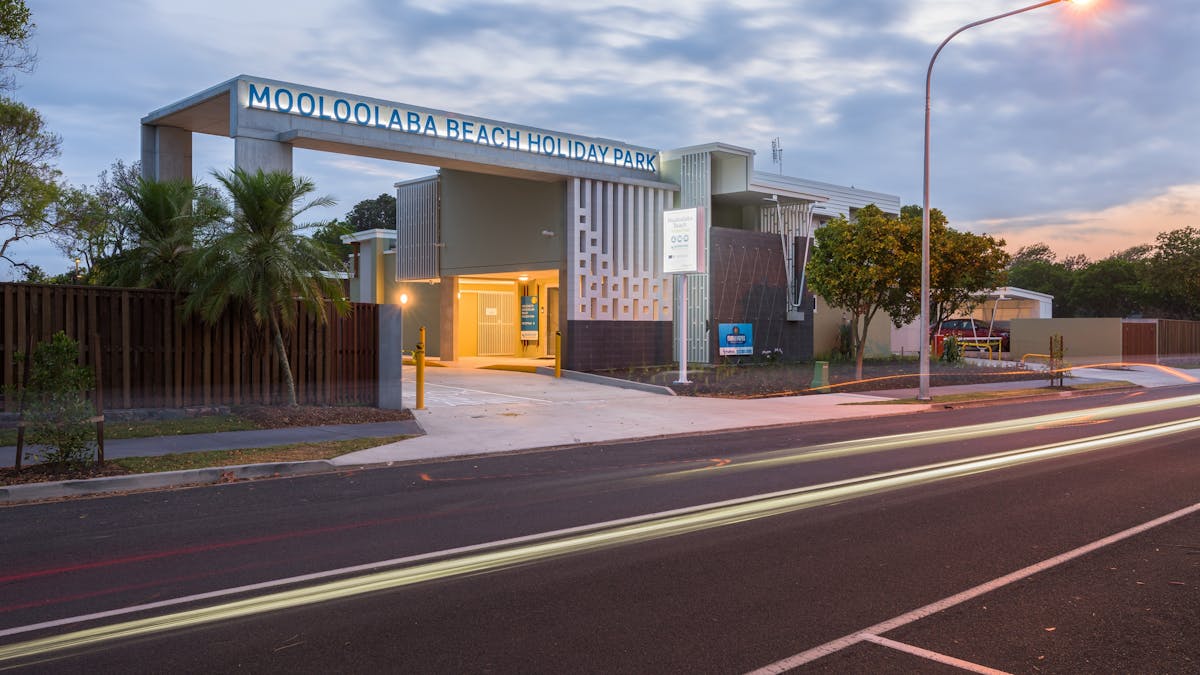Shot of Mooloolaba Beach Holiday Park entrance at dusk with lights on