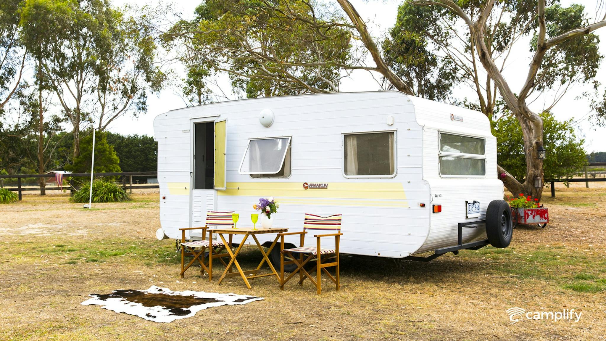 caravan with camp chair set up outside