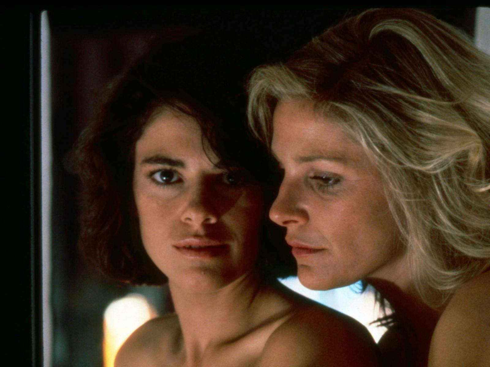 Two women one blonde and one brunette looking at camera