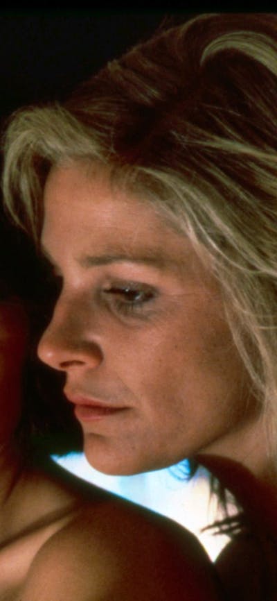 Two women one blonde and one brunette looking at camera