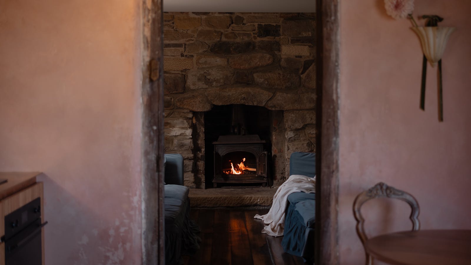 A cozy lounge surrounds wood fire