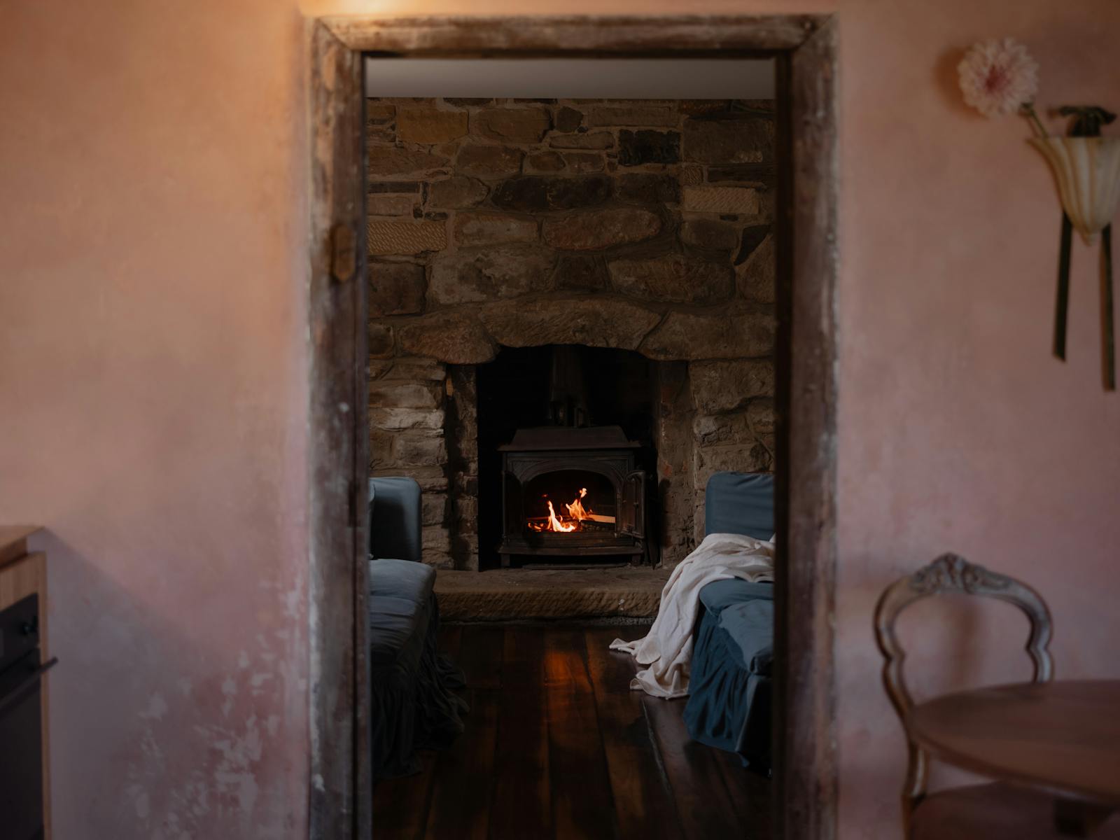 lounge with wood fire, two blue couches