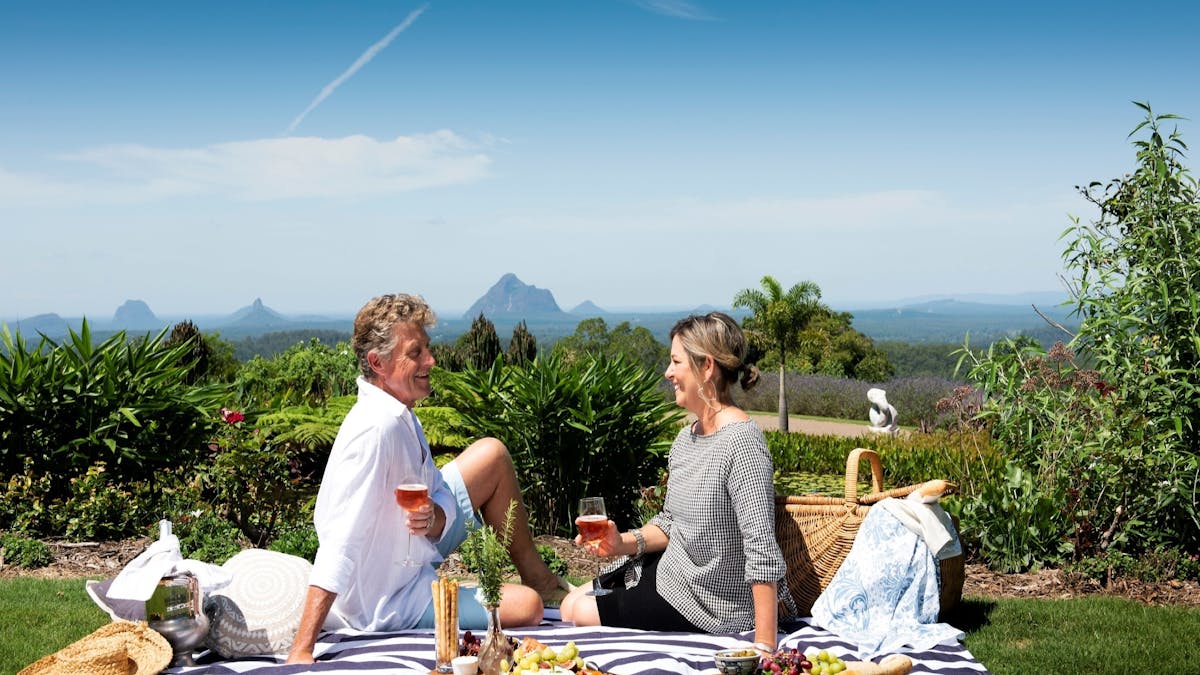 Couple having picnic with Mountain backdrop