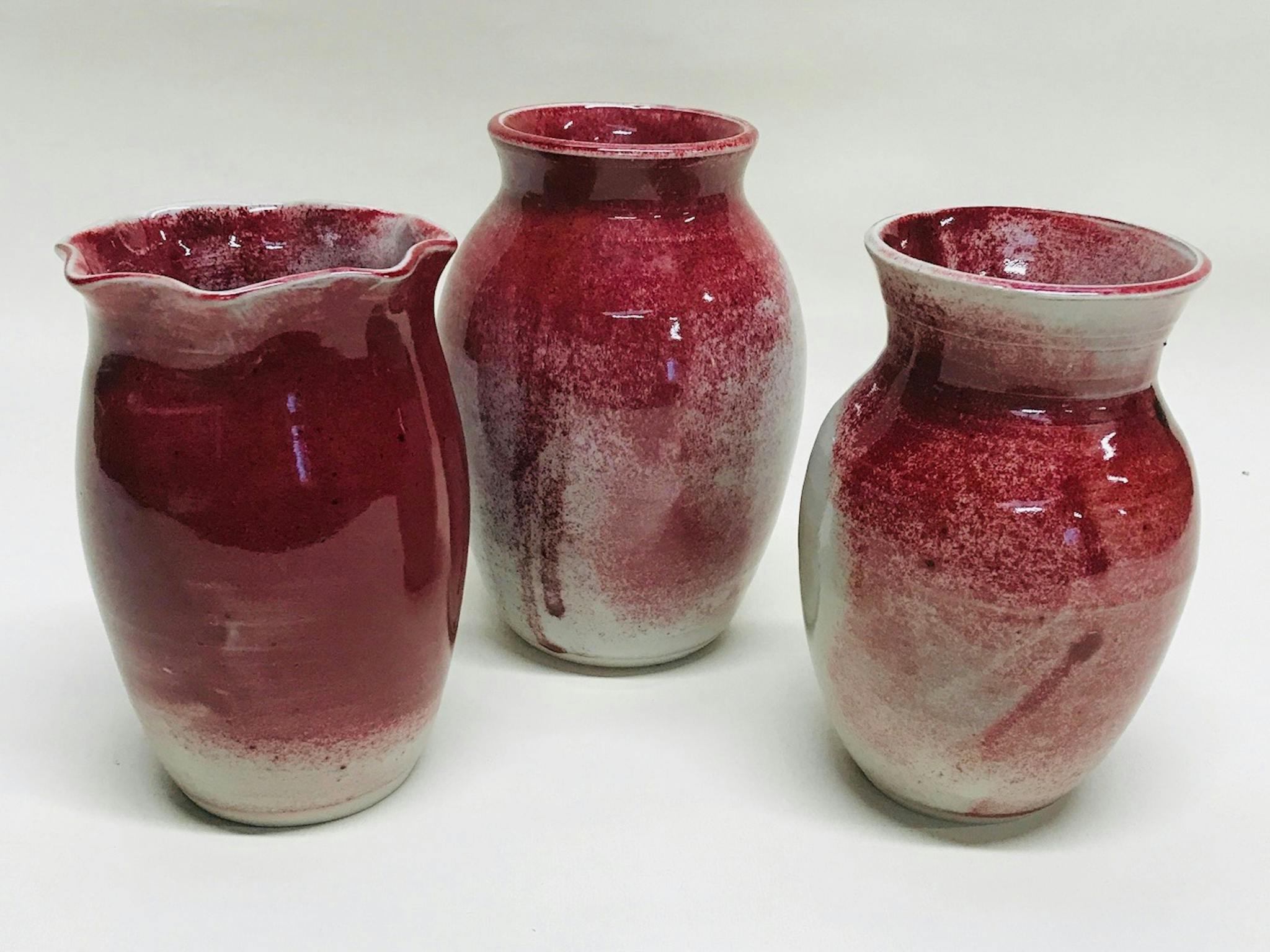 Three red vases