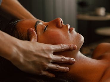 Spa therapist performing facial