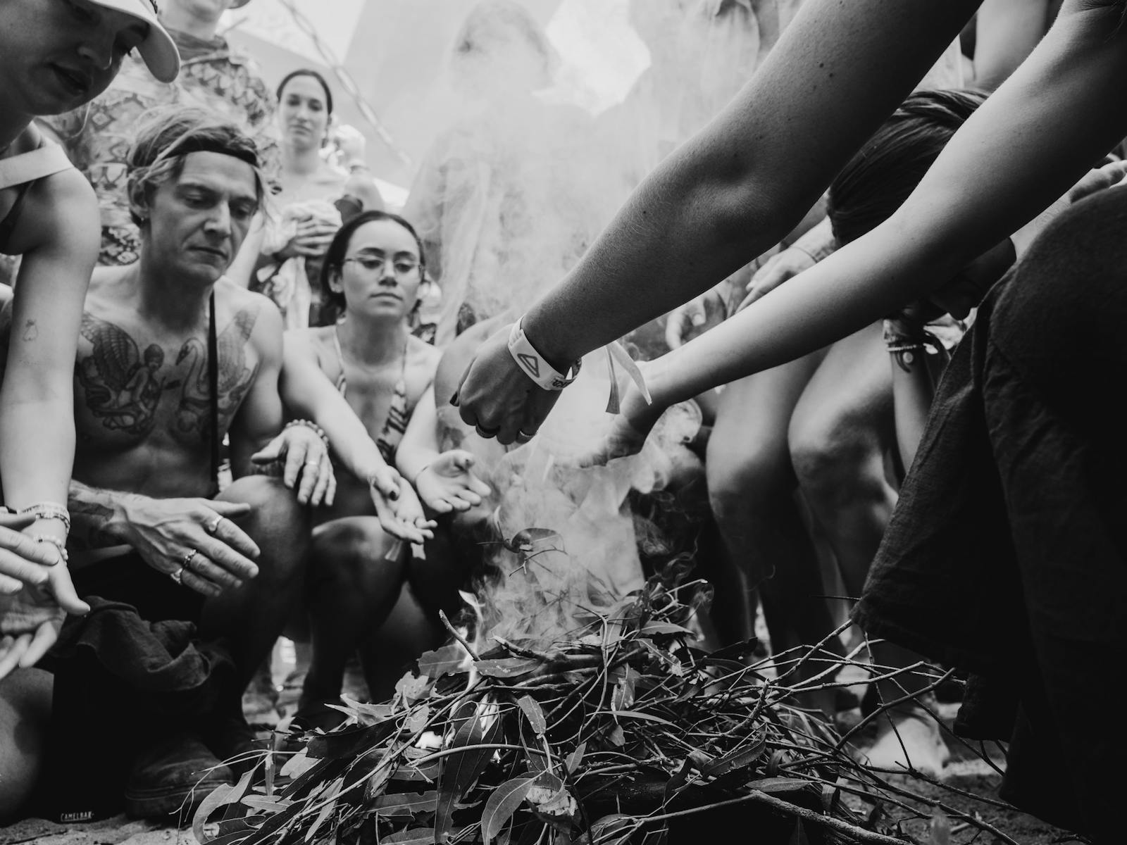 People getting smoked at Welcome to Country smoking ceremony at Strawberry Fields Festival