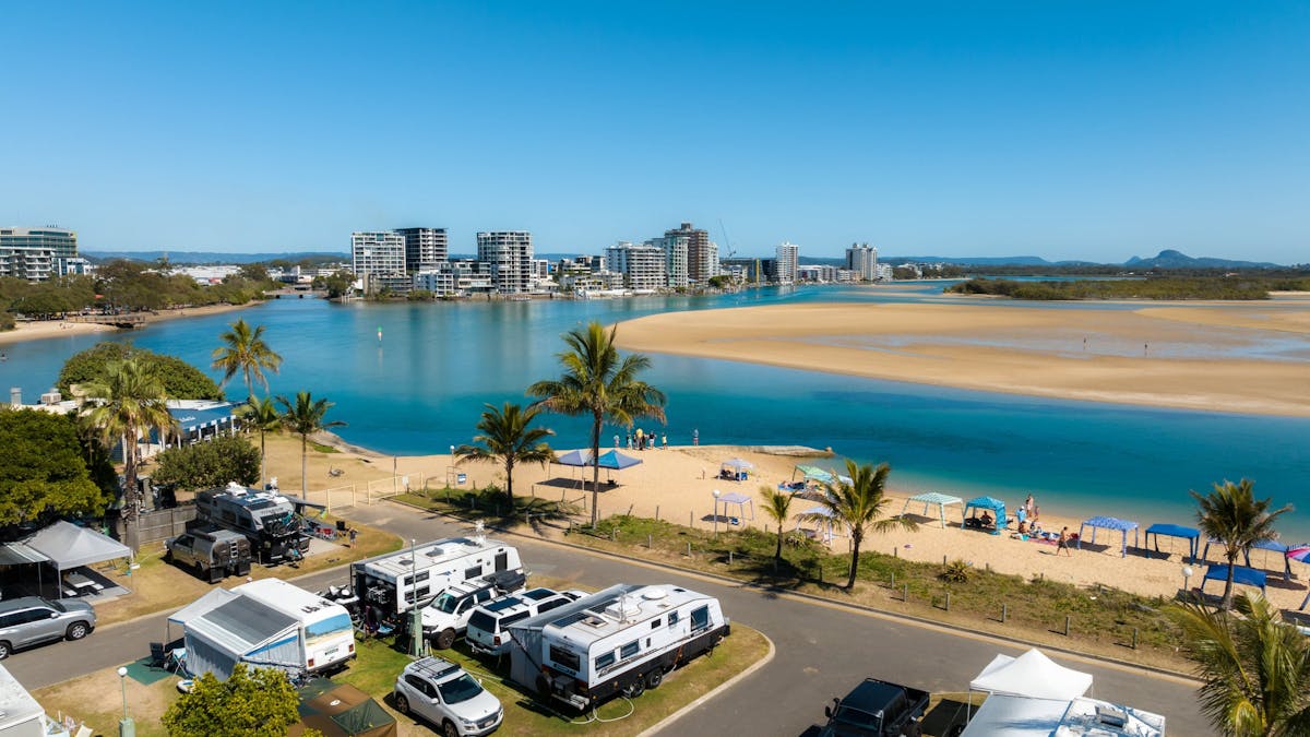low arial shot of cotton tree holiday park with a couple caravans & views of the river & apartments low arial shot of cotton tree holiday park with a couple caravans & views of the river & apartments