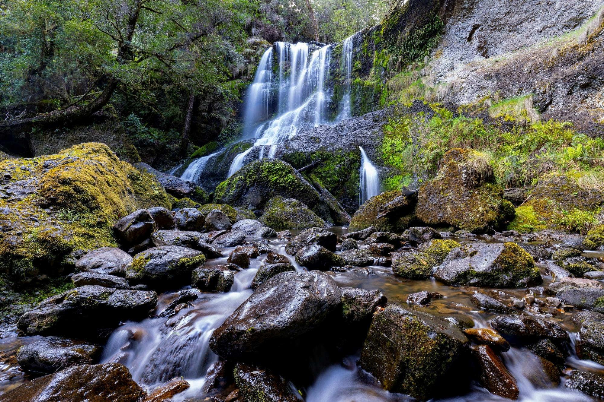 Champagne Falls, Beautiful long exposure of water flow over moss covered rocks at Moina, Tasmania