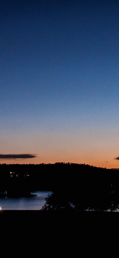 Canberra at sunset showing the Carillon bell tower and Parliament House