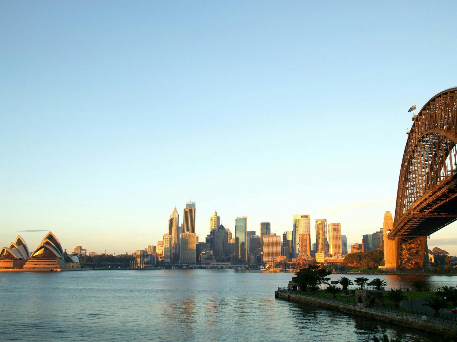 view over sydney harbour with sydney opera house on the left and bridge on the right