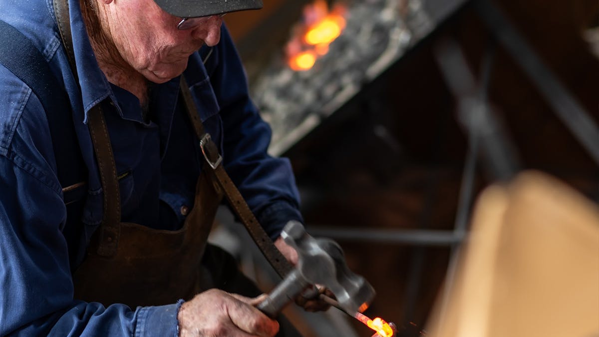 Blacksmith hammering heated metal. Blacksmith hammering heated metal.