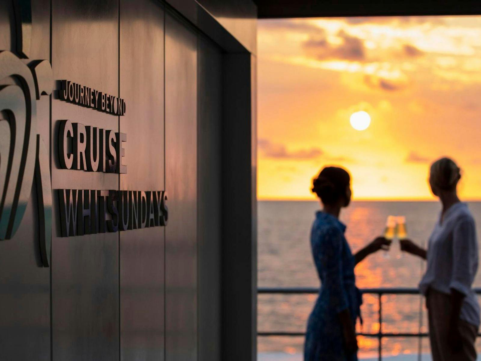 Two people enjoying a drink at sunset