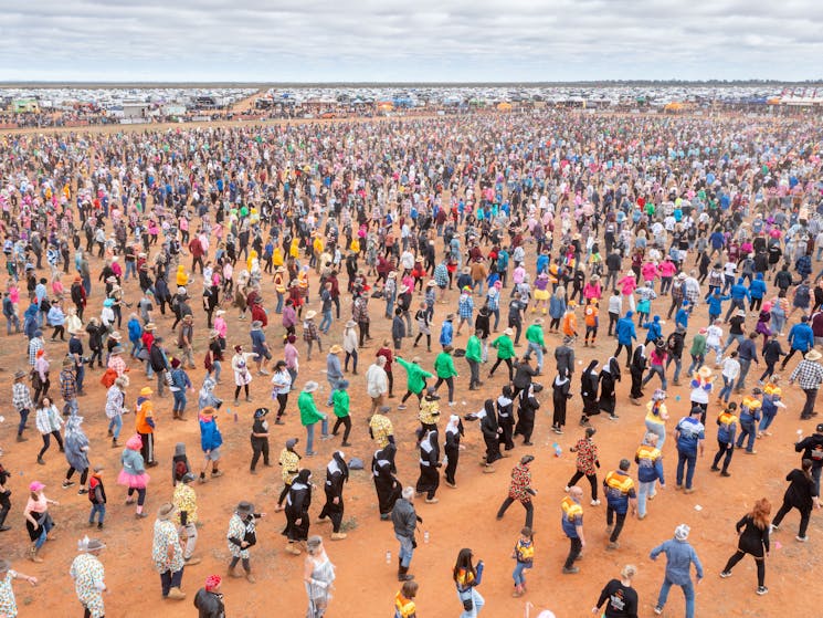 Thousands of festival-goers perform a joint square dance at the Mundi Mundi Bash
