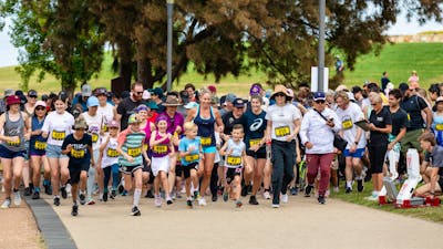 Group of people running and participating in the fun run