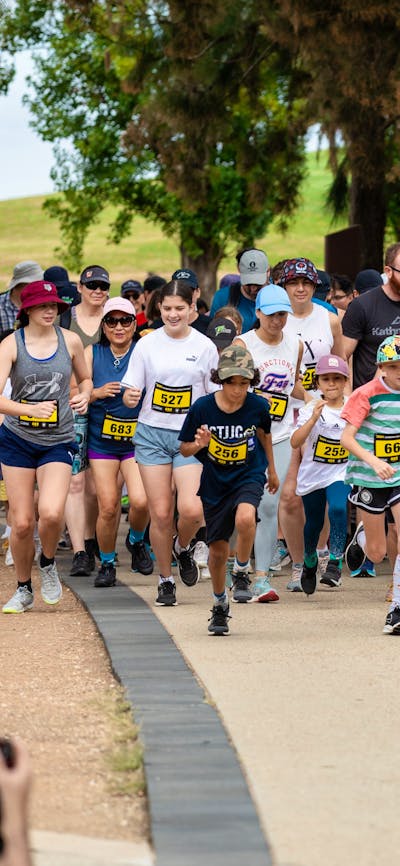 Group of people running and participating in the fun run