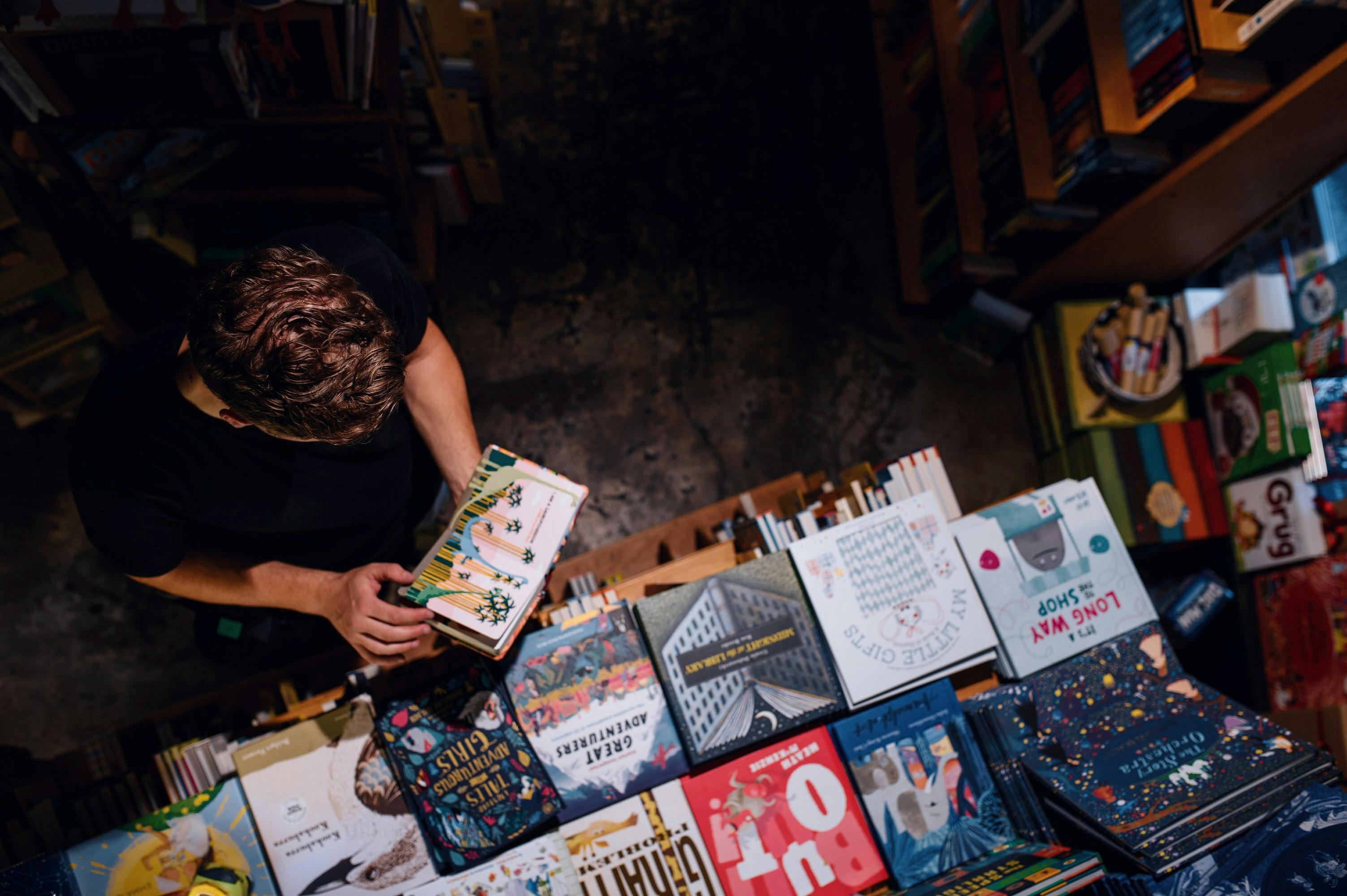 Man browsing books at the Berkelouw Paddington book store on Oxford Street, Paddington