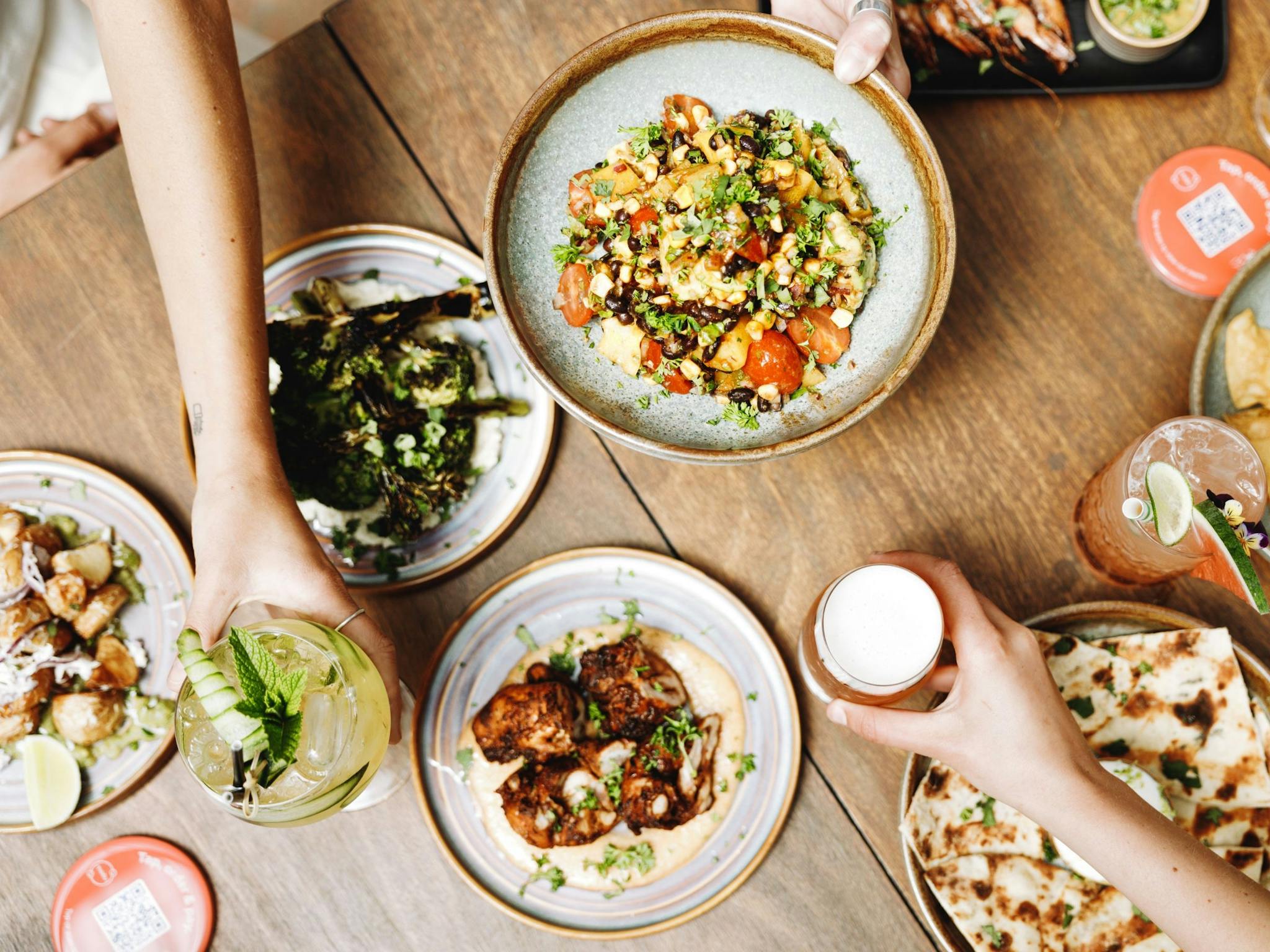 A range of Southern American dishes and drinks on the table at The Yard Bright