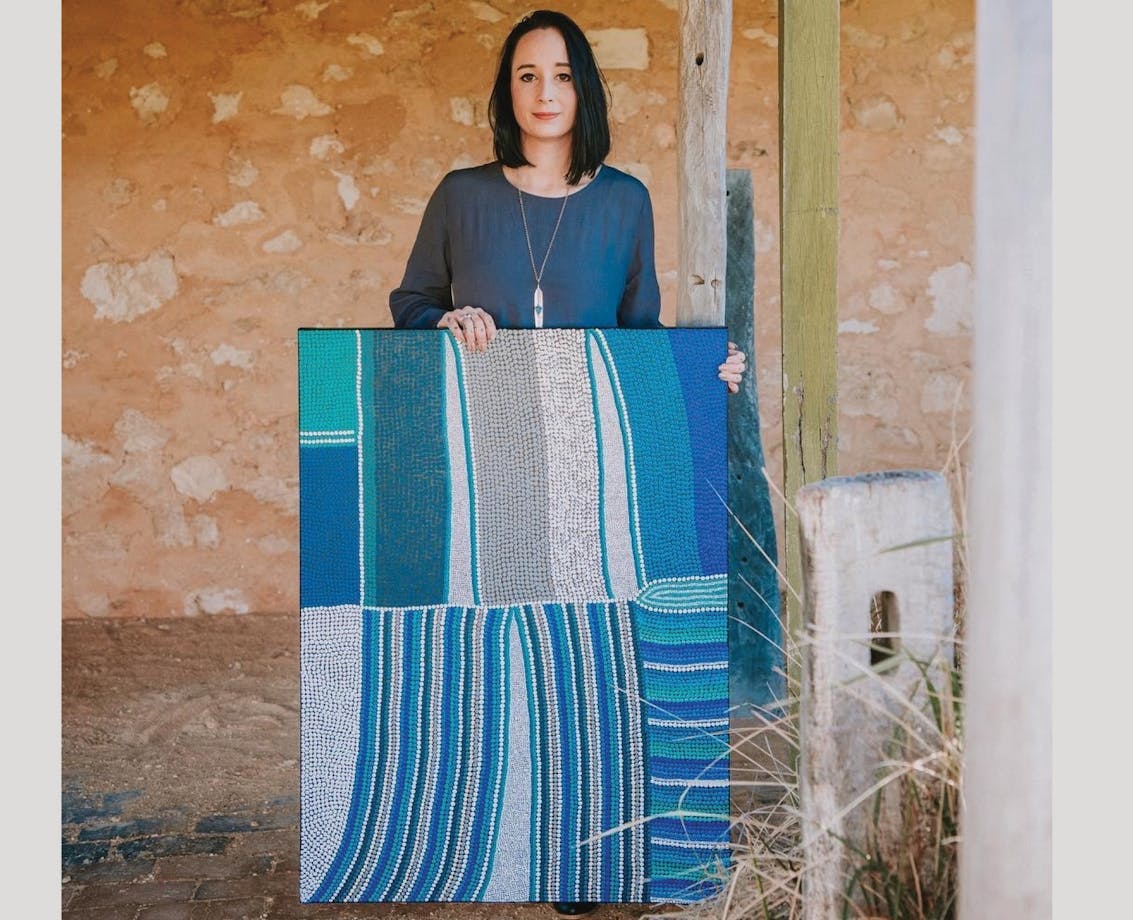 Amanda Westley with a large contemporary dot style painting