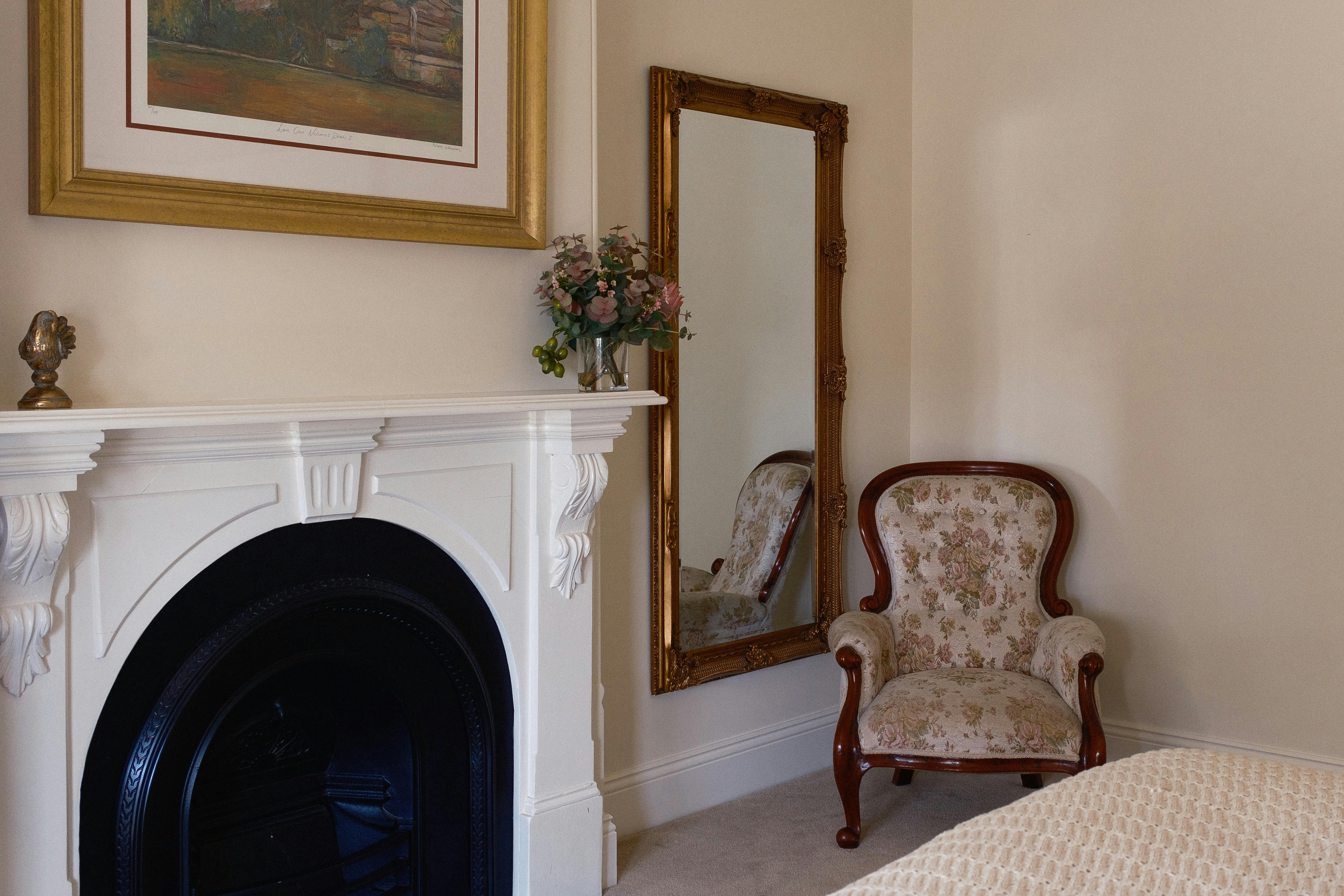 mirror and antique chair and mantlepiece