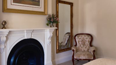 mirror and antique chair and mantlepiece