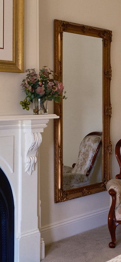 mirror and antique chair and mantlepiece