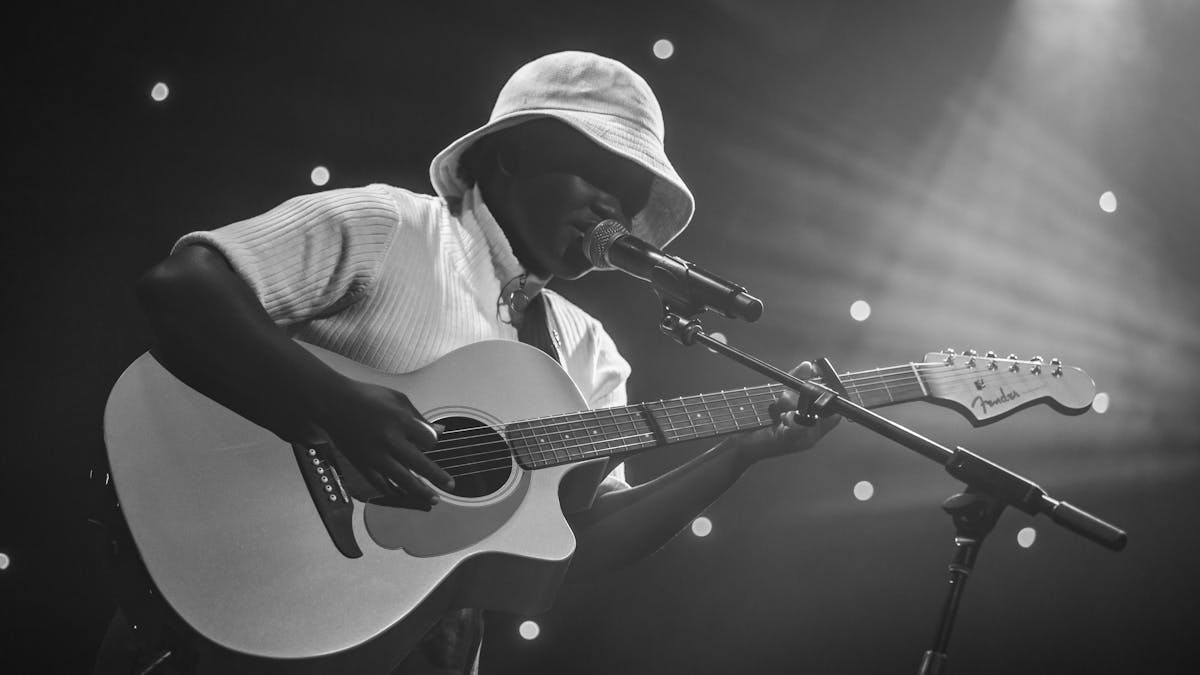 Beckah Amani playing guitar and singing