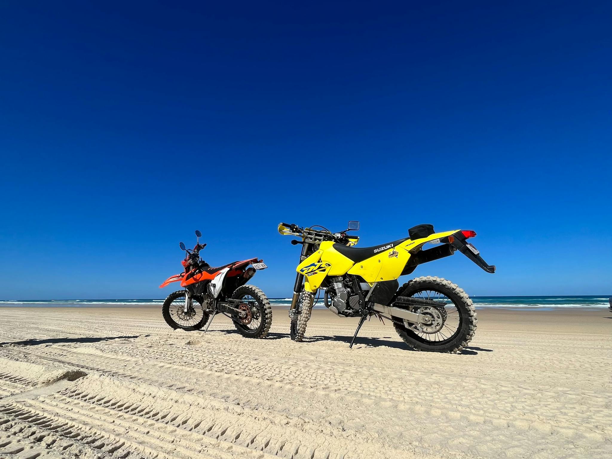 Two dirt bikes on the beach Two dirt bikes on the beach