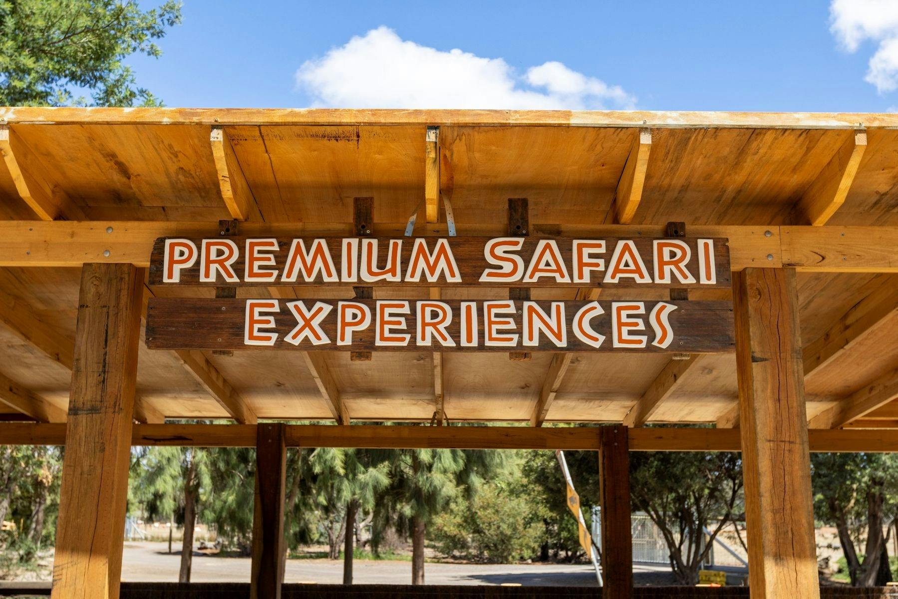 A board displaying the words premium safari experience