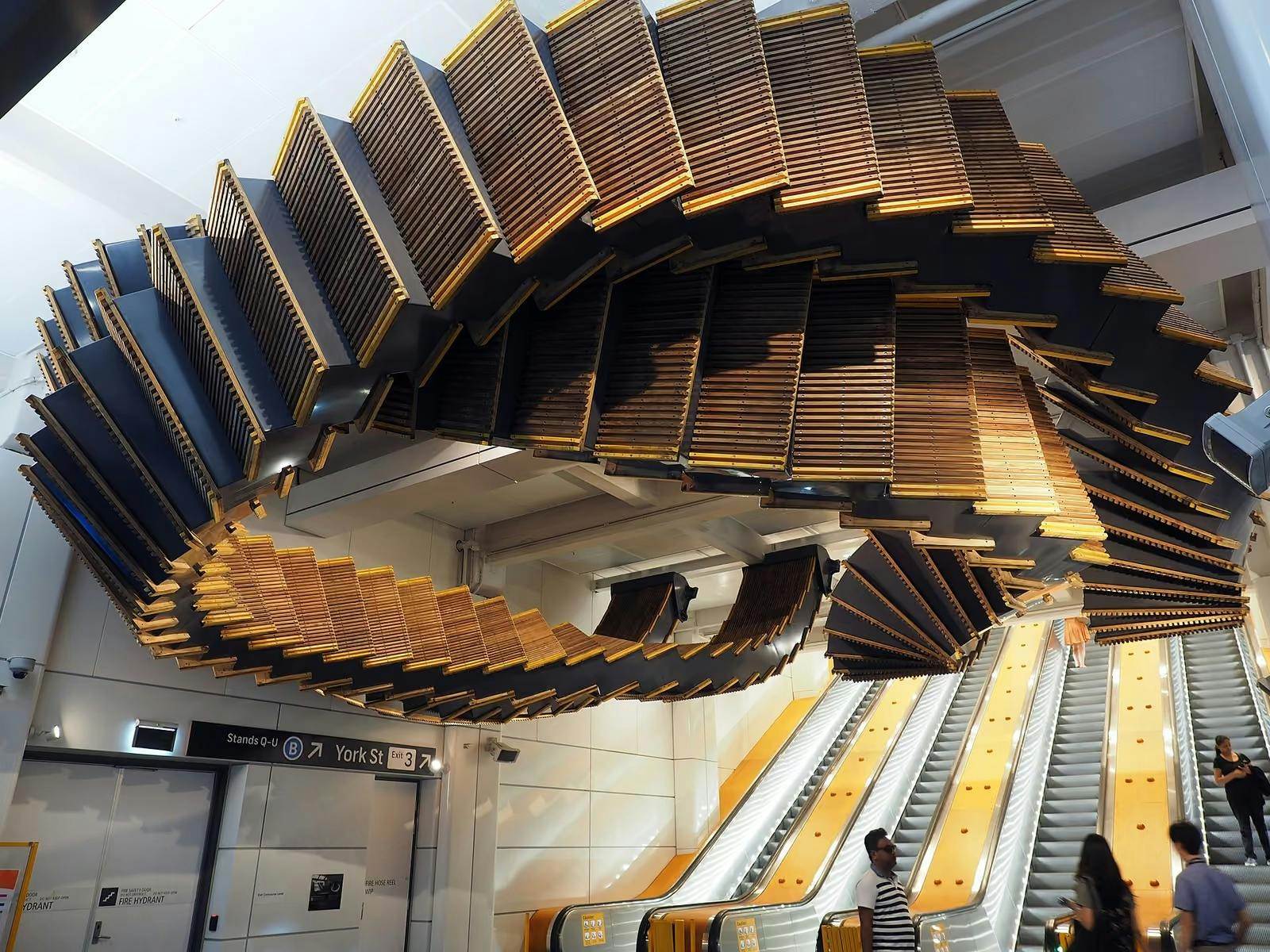 Suspended wooden escalator artwork above the escalators at Wynyard Station in Sydney.