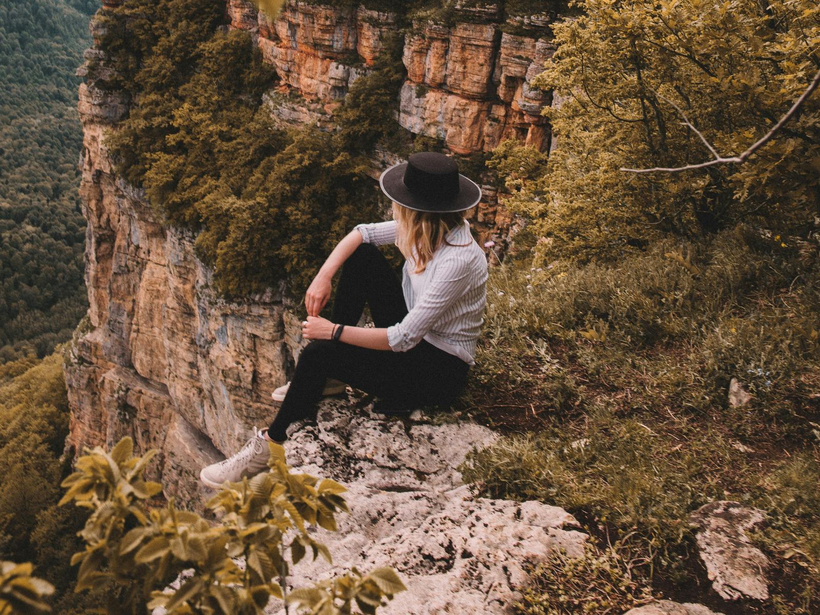 Woman sitting in nature, contemplative