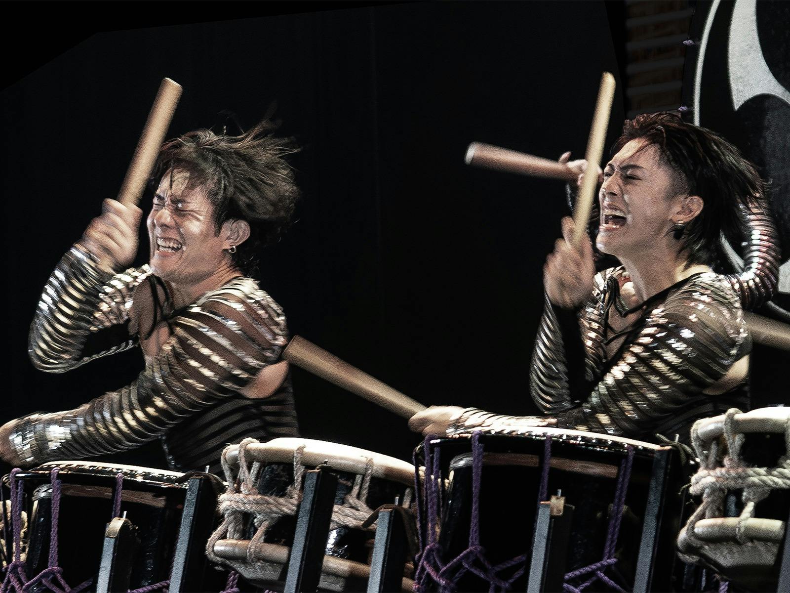2 men playing drums