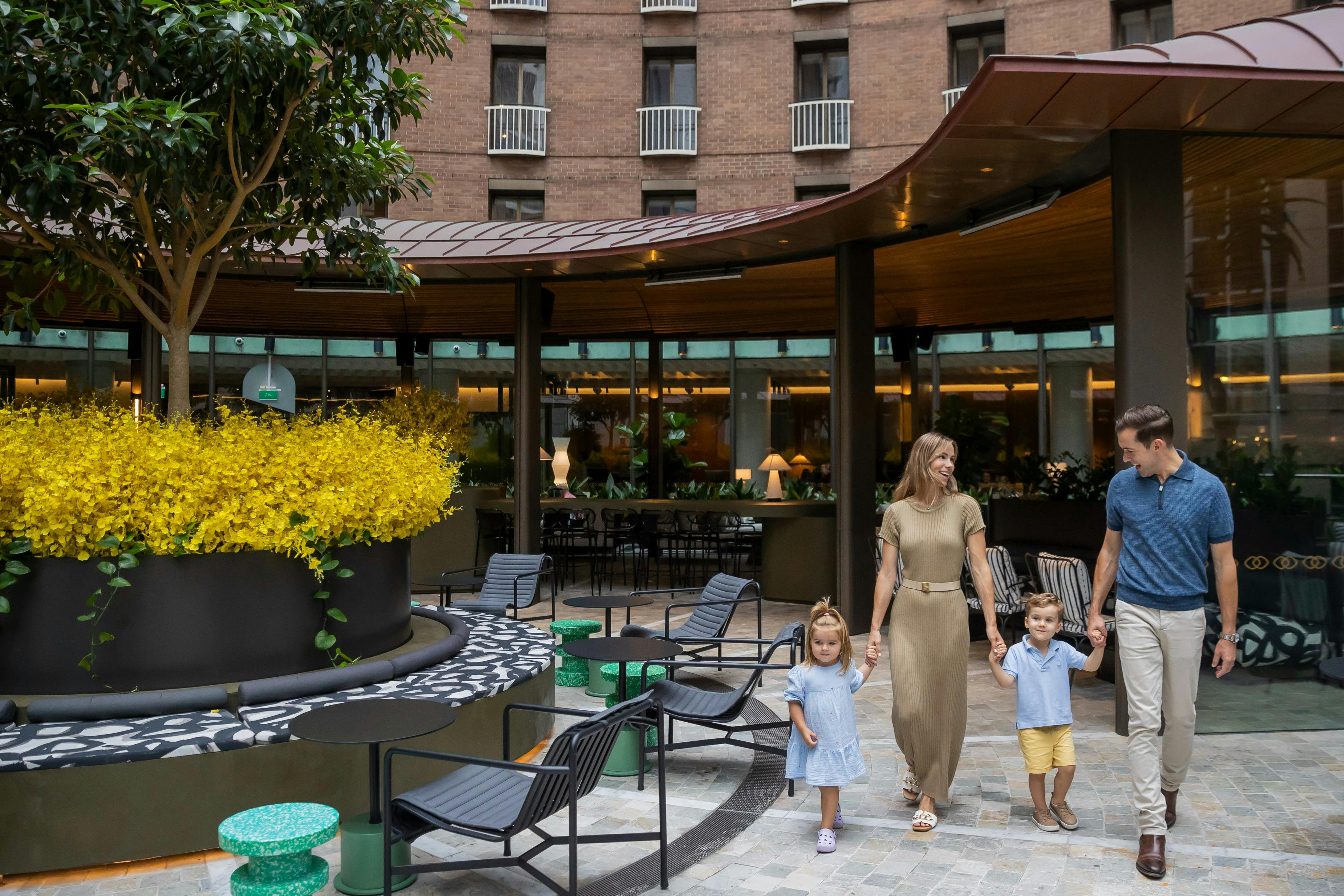 Family enjoying their getaway at the outdoor terrace of Sofitel Sydney Wentworth