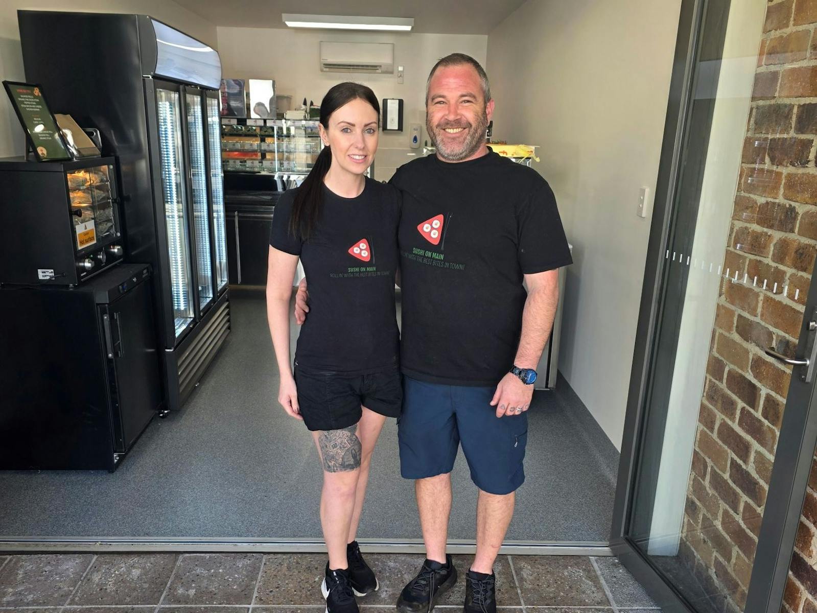 image of the two owners standing out front of the store