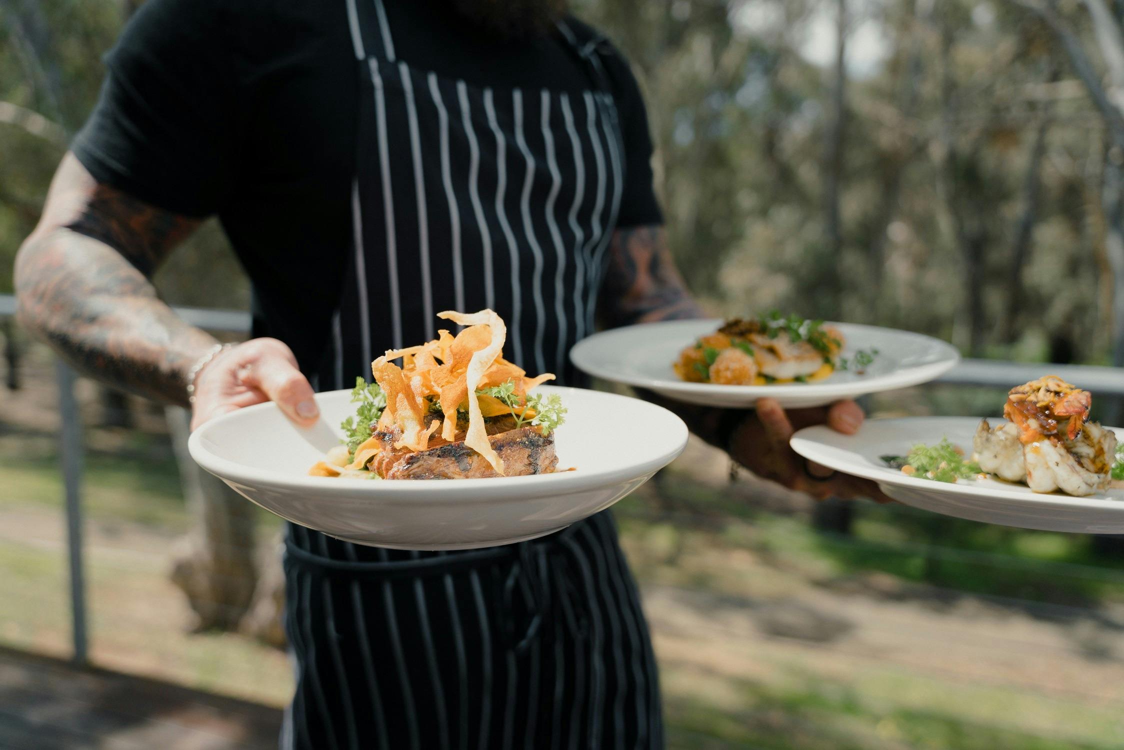 Man serving 3 plates of food
