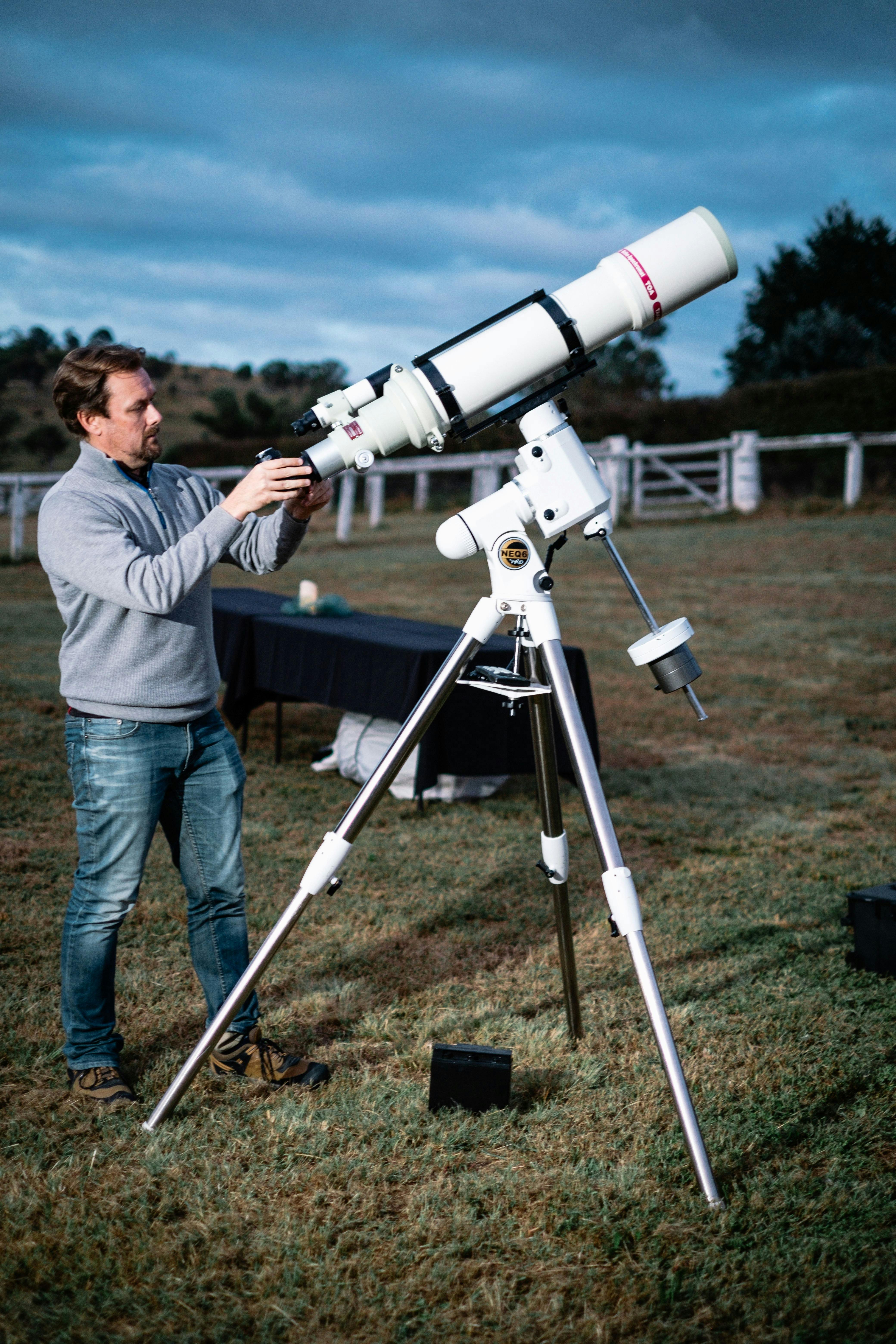 Man adjusts telescope at Lanyon Homestead