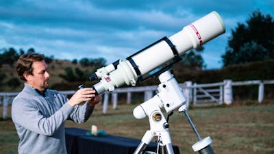 Man adjusts telescope at Lanyon Homestead