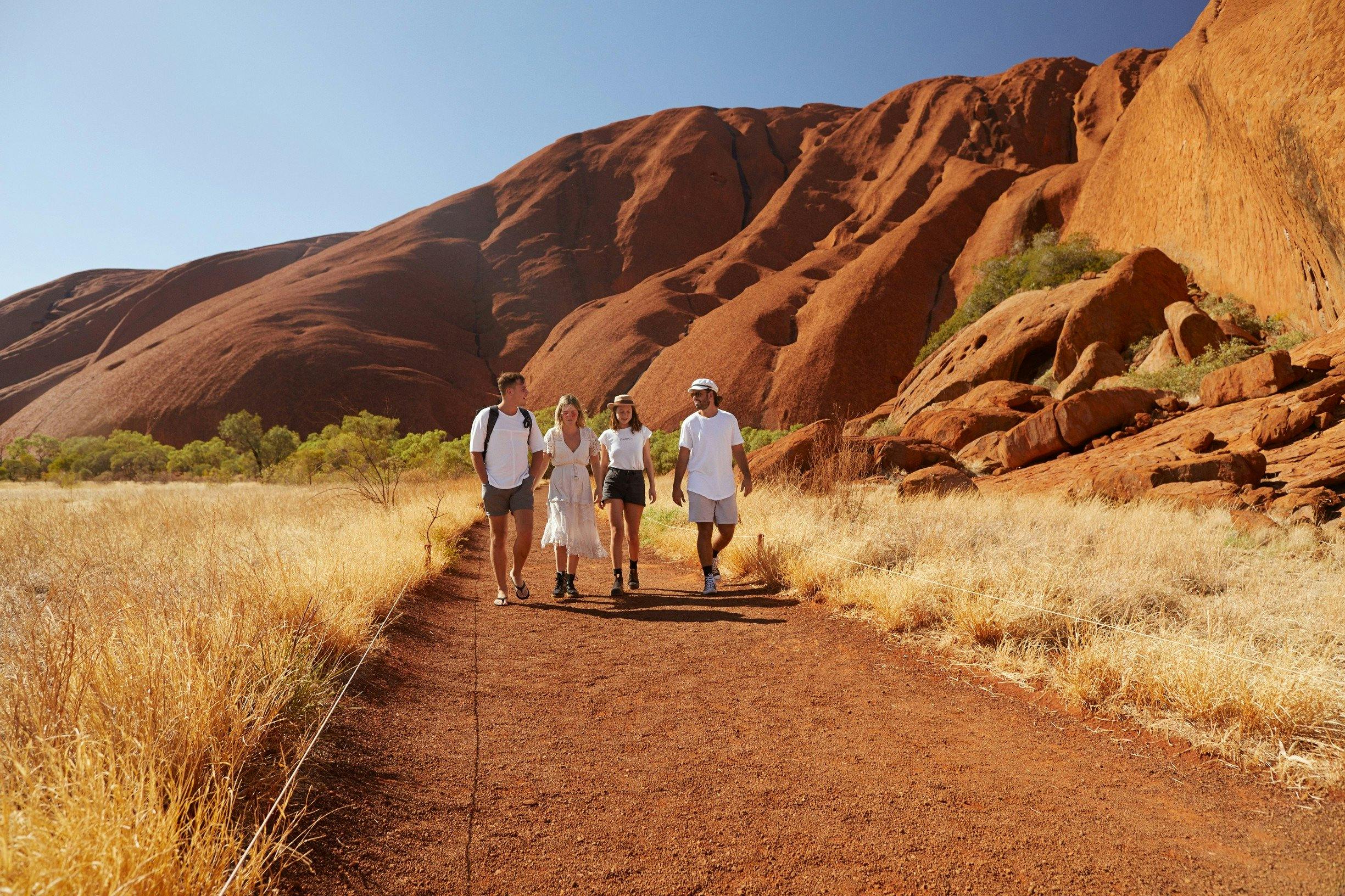 A group of friends walking around Uluru
