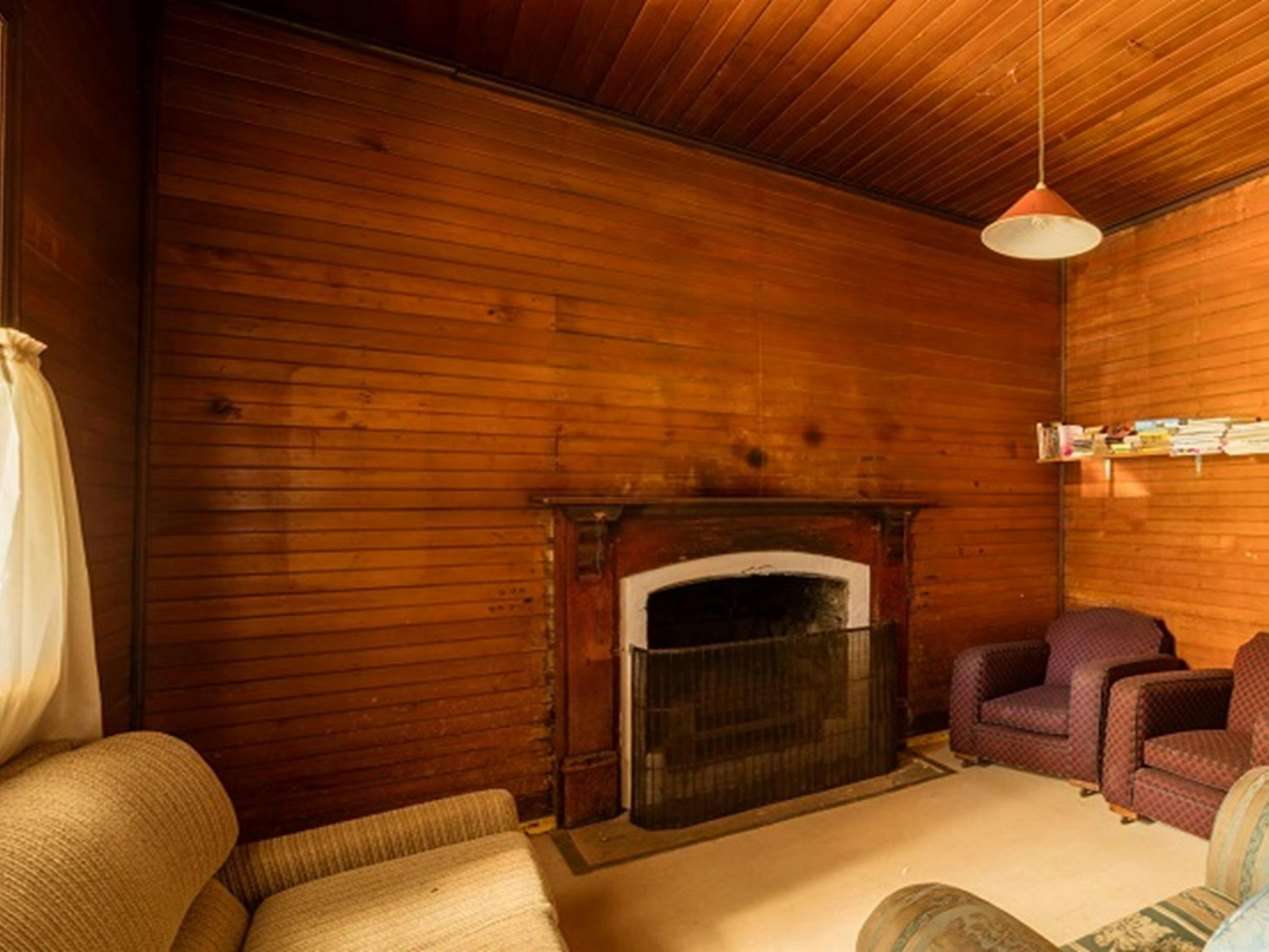 Daffodil Cottage fireplace and living room, Kosciuszko National Park. Photo: Murray Vanderveer/OEH