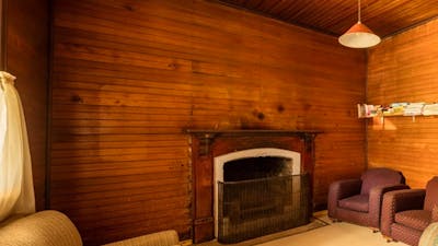 Daffodil Cottage fireplace and living room, Kosciuszko National Park. Photo: Murray Vanderveer/OEH